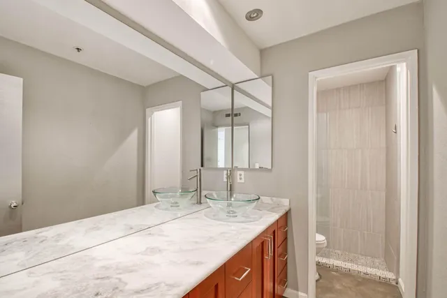 a bathroom with a granite countertop sink and a mirror