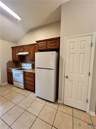 a kitchen with stainless steel appliances a refrigerator and cabinets