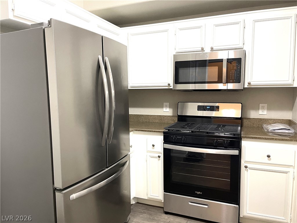 10001 Peace Way, Unit 1327 Las Vegas, NV 89147 - Photo 8 of 21 Modern kitchen equipped with sleek stainless steel appliances, ideal for culinary creations.
