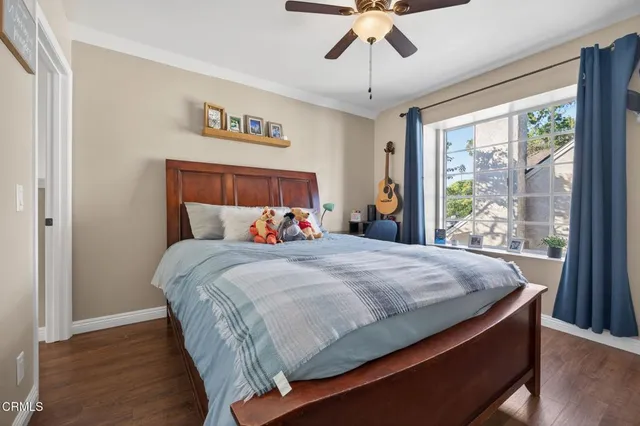 a bed sitting in a bedroom next to a window