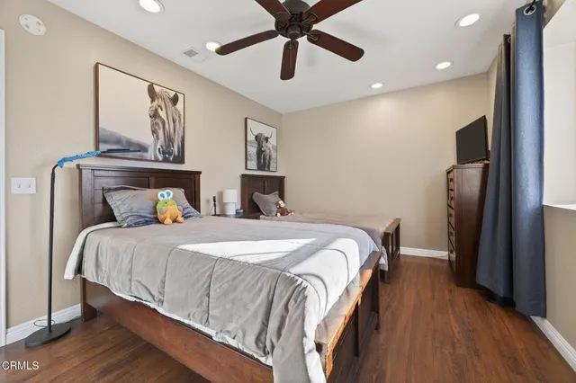 a bedroom with bed and wooden floor