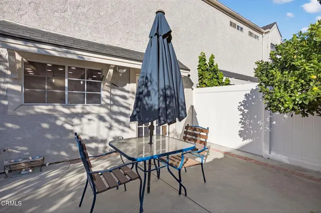 a outdoor space with a table and chairs