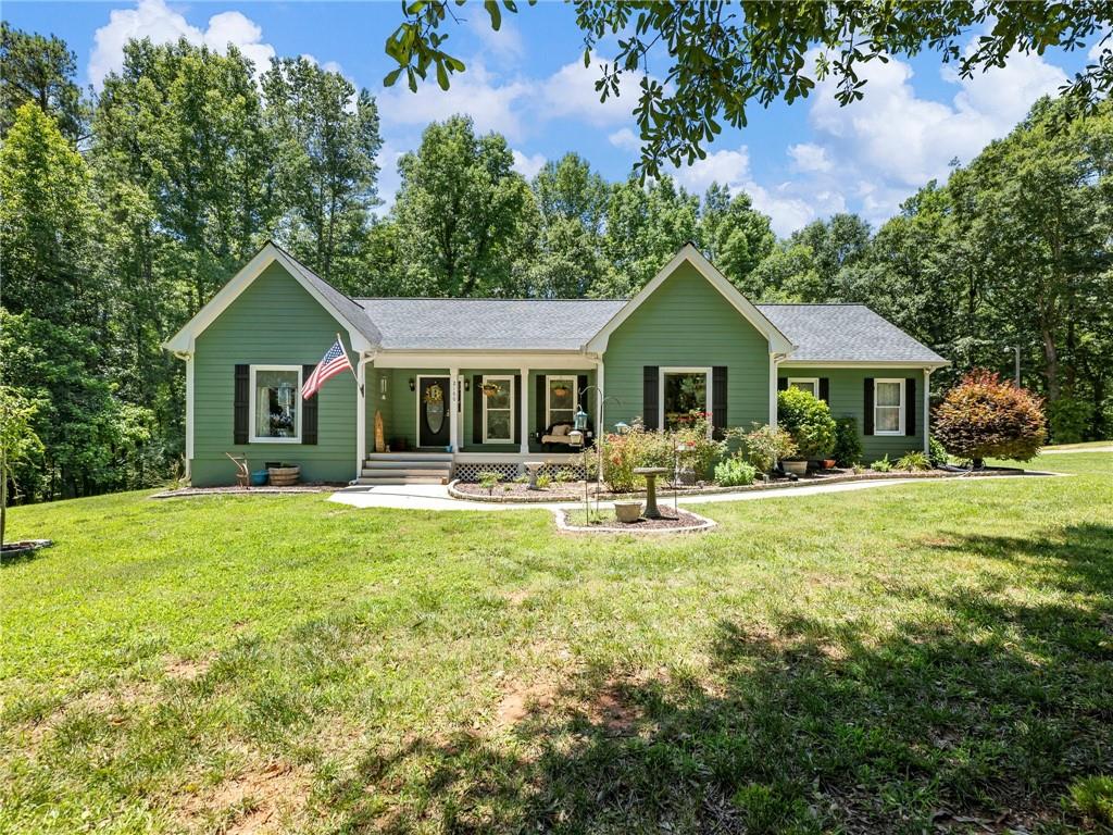 2160 West H Hayes Road Jefferson, GA 30549 - Photo 1 of 1 a front view of a house with swimming pool having outdoor seating