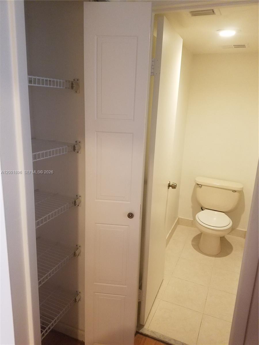 310 Racquet Club Road, Unit 204 Weston, FL 33326 - Photo 15 of 22 a bathroom with a granite countertop sink and a toilet