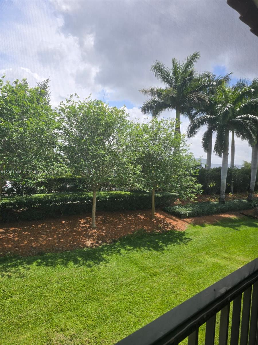 310 Racquet Club Road, Unit 204 Weston, FL 33326 - Photo 20 of 22 a backyard of a house with lots of green space and lake view