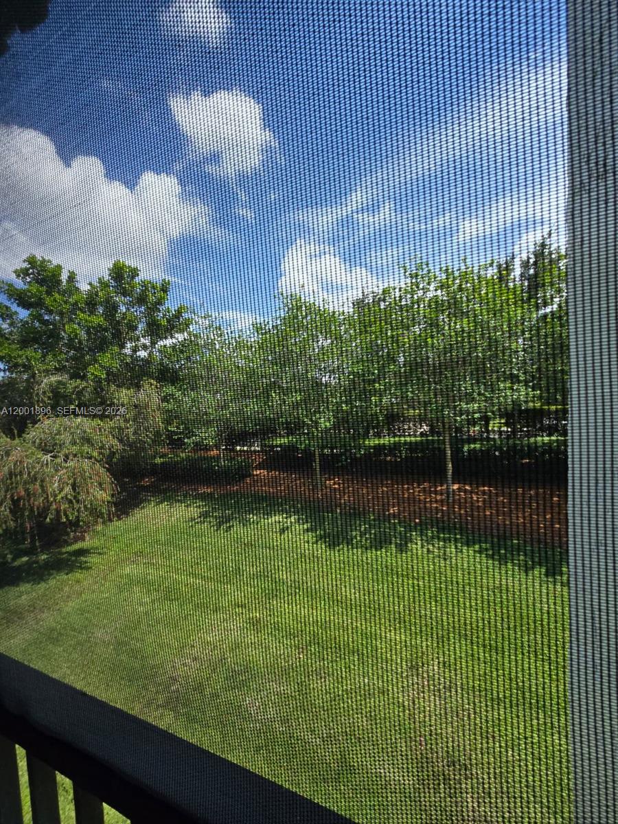 310 Racquet Club Road, Unit 204 Weston, FL 33326 - Photo 21 of 22 a view of a swimming pool with a garden