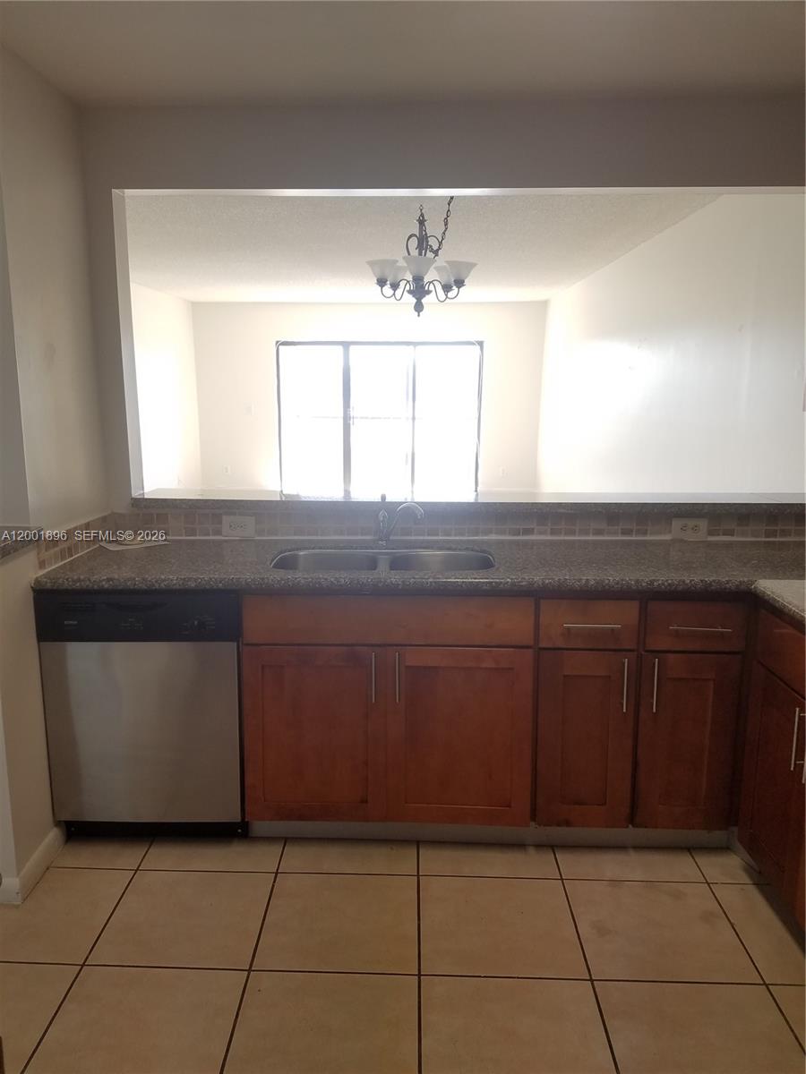 310 Racquet Club Road, Unit 204 Weston, FL 33326 - Photo 5 of 22 a kitchen with a sink and a mirror