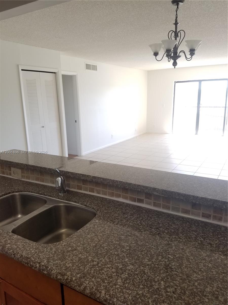 310 Racquet Club Road, Unit 204 Weston, FL 33326 - Photo 6 of 22 a kitchen with a sink and a window