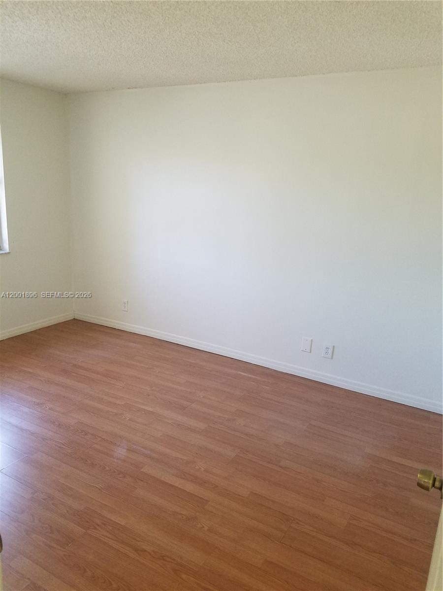 310 Racquet Club Road, Unit 204 Weston, FL 33326 - Photo 7 of 22 wooden floor in a empty room
