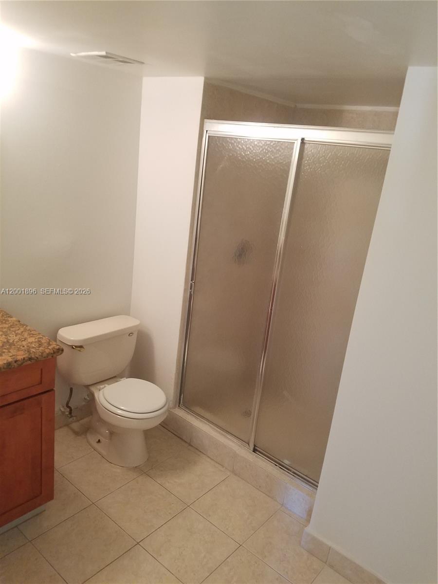 310 Racquet Club Road, Unit 204 Weston, FL 33326 - Photo 9 of 22 a white toilet sitting next to a shower
