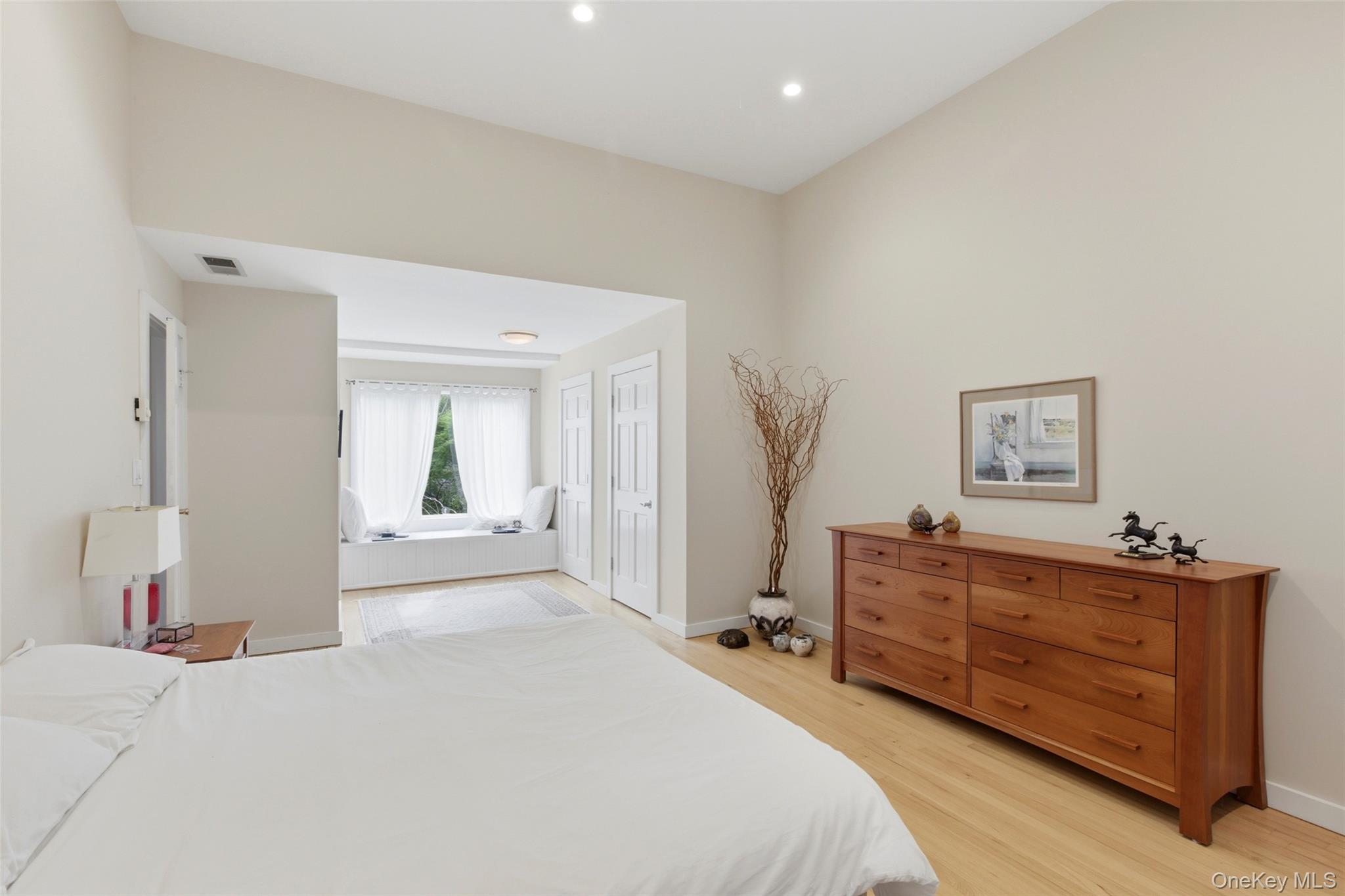 7 Gun Path Setauket, NY 11733 - Photo 19 of 34 a spacious bedroom with a bed and a dresser