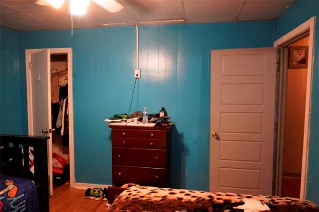 a bedroom with a bed and a dresser