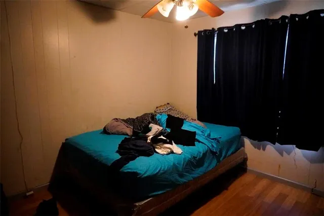 a bed sitting in a bedroom next to a cabinet