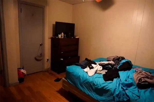 a bed room with a bed and a television