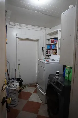a room with a refrigerator and cabinets