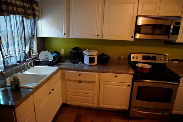 a bedroom with a bed and dresser with mirror