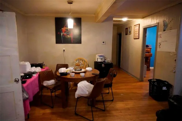 a view of a workspace with furniture and wooden floor