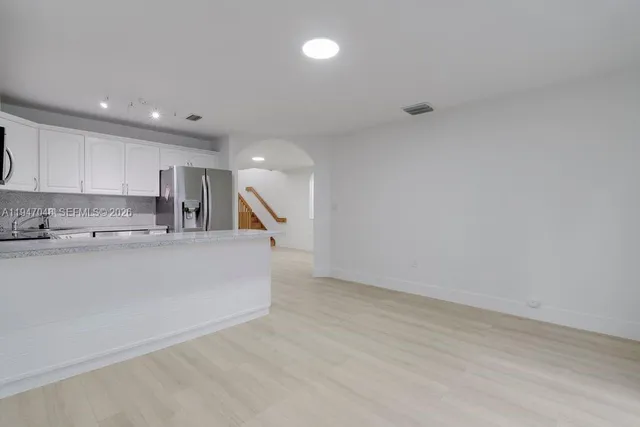 a view of kitchen with center island and stainless steel appliances