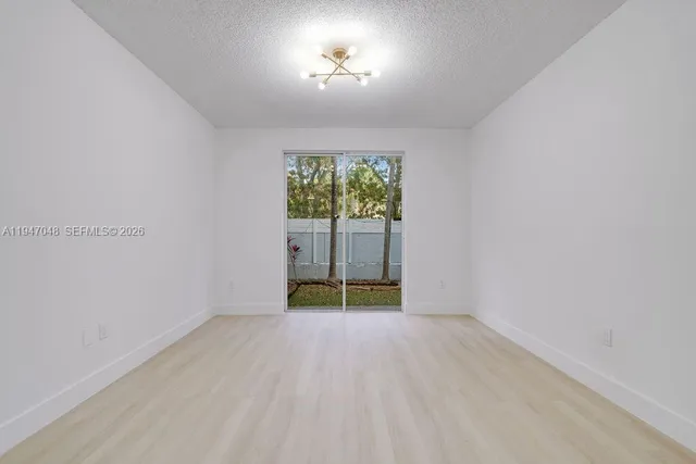 a kitchen with stainless steel appliances granite countertop a refrigerator a stove and a sink with wooden floor