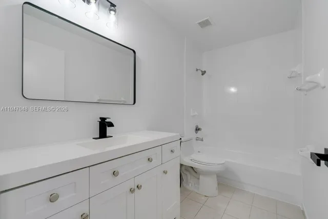 a bathroom with a sink toilet and mirror