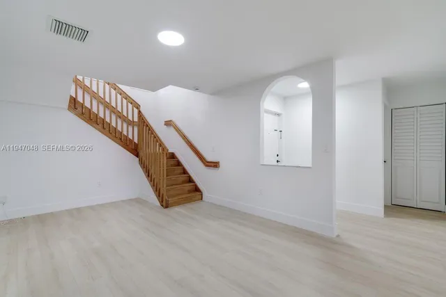 a view of an entryway with wooden floor