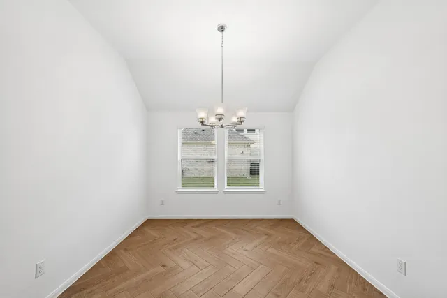 a view of a room with windows and ceiling fan