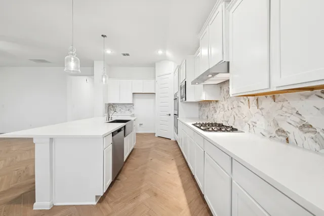 a large kitchen with kitchen island a sink stainless steel appliances and cabinets