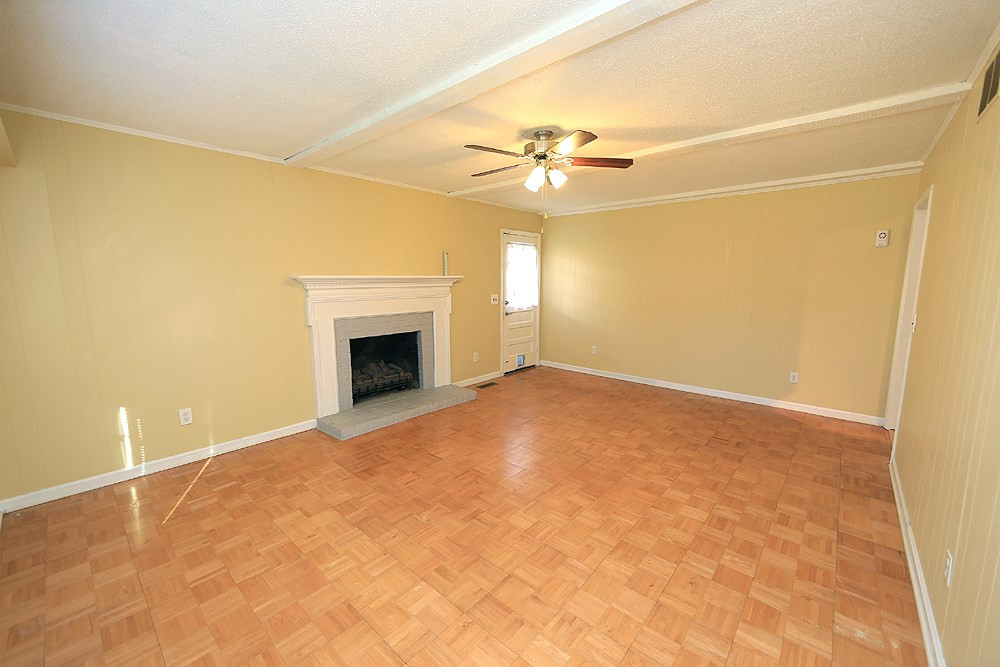 6628 Keystone Drive Raleigh, NC 27612 - Photo 16 of 28 The family room-not staged (lots of great wall space and options for furniture placement). There is a gas log fireplace with brick surround. Family Room