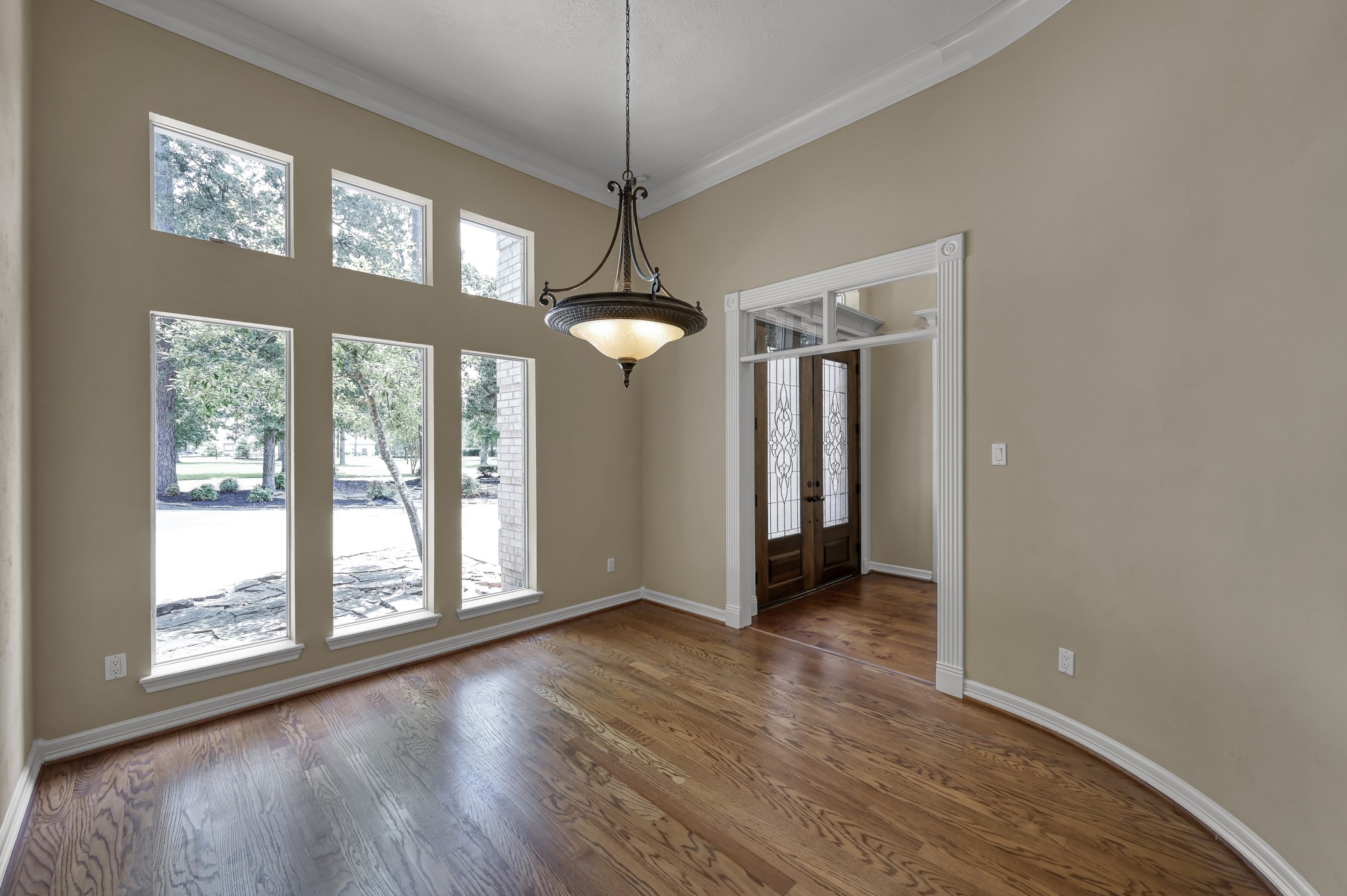 2205 Longmire Road Conroe, TX 77304 - Photo 21 of 49 Formal Dining Room with a large wall of windows that let in plenty of natural light!