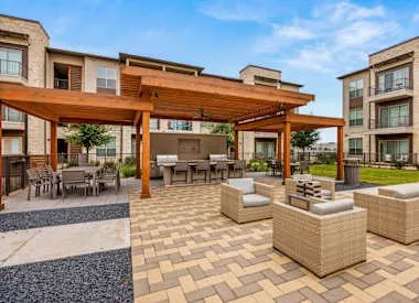 a view of a patio with dining table and chairs