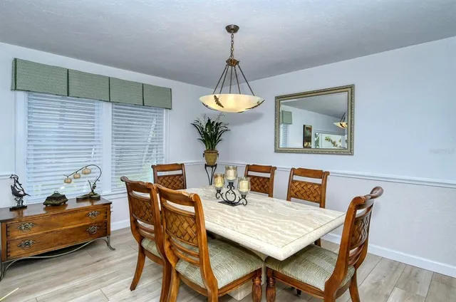 a dining room with furniture and window