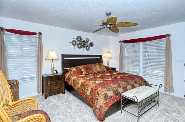 a bedroom with a bed dresser and window