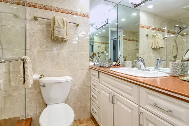 a view of a balcony with wooden floor and a houses