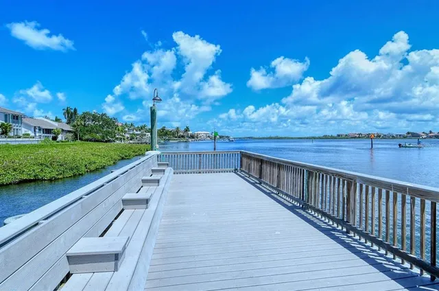 a vase of flowers sitting in front of a house
