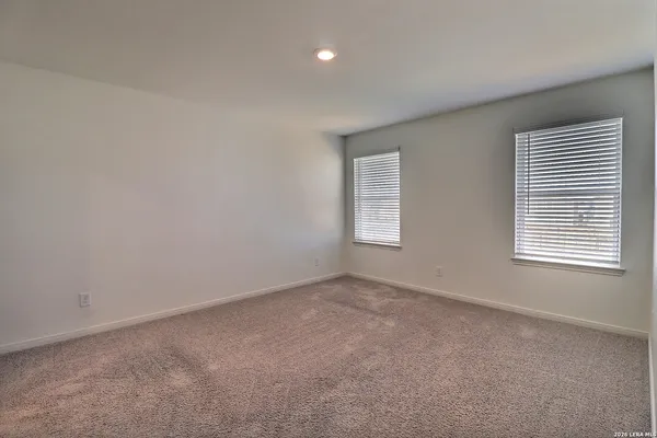a bathroom with a granite countertop sink a mirror and a bathtub