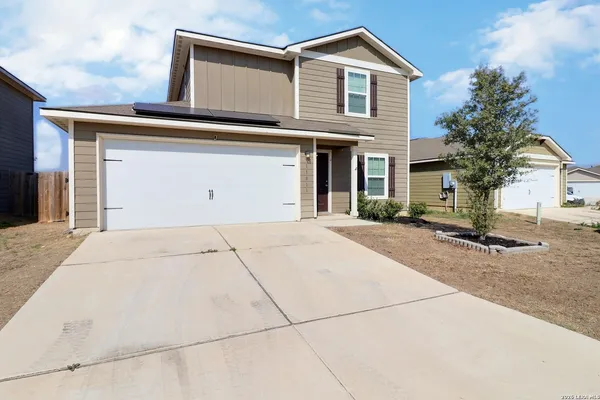 a view of a house with a yard and garage