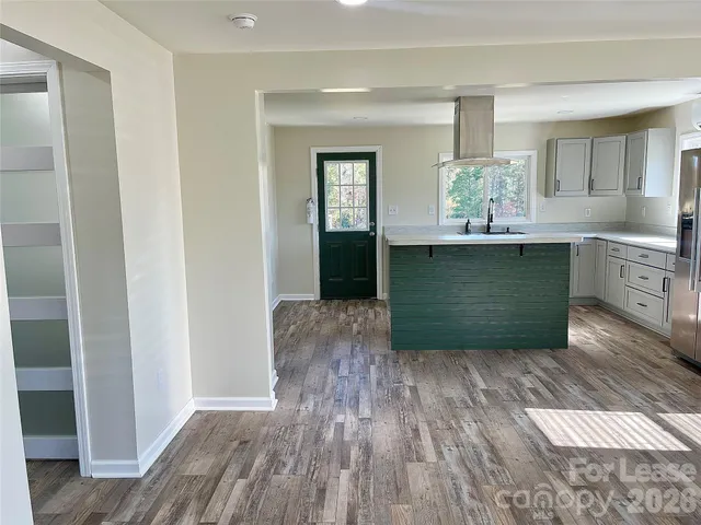 a view of kitchen and hall with wooden floor