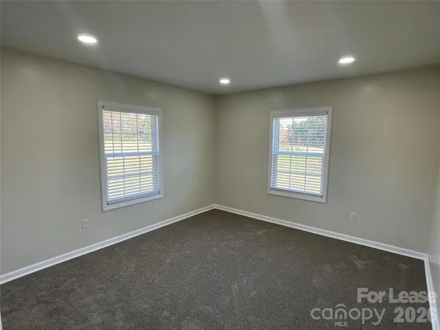 an empty room with a empty space and windows