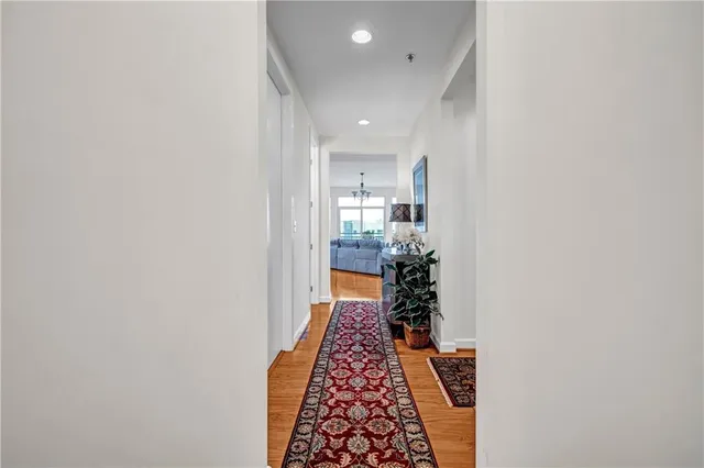 a kitchen with stainless steel appliances granite countertop a table chairs and a refrigerator