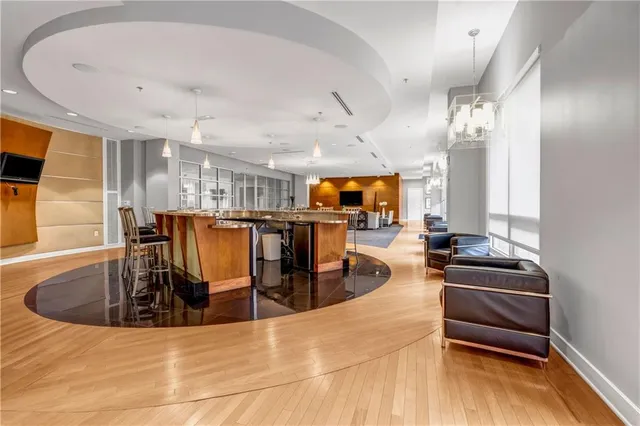 a living room with lots of furniture and a large window