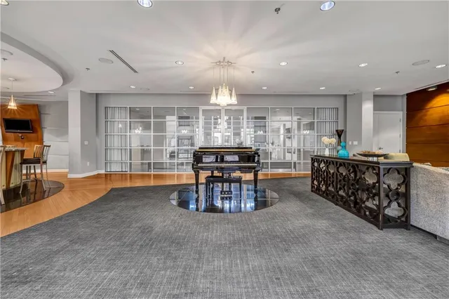 a living room with furniture and a chandelier