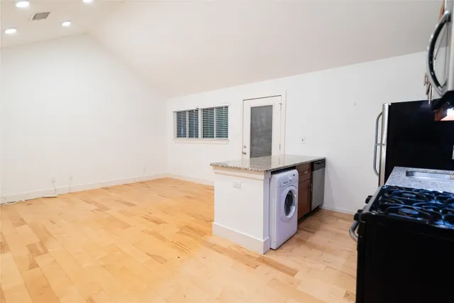 a kitchen with stainless steel appliances a stove a microwave and a refrigerator