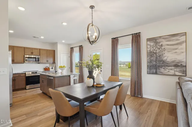 a view of a dining room with furniture window and wooden floor