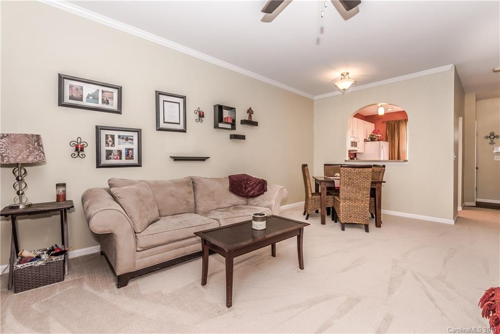 816 Gentlewinds Court, Unit 816 Fort Mill, SC 29708 - Photo 11 of 24 a living room with furniture a rug and a chandelier