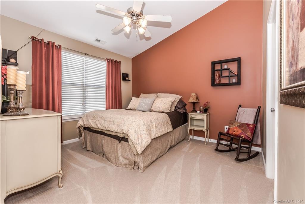 816 Gentlewinds Court, Unit 816 Fort Mill, SC 29708 - Photo 15 of 24 a bed room with a bed and a chair