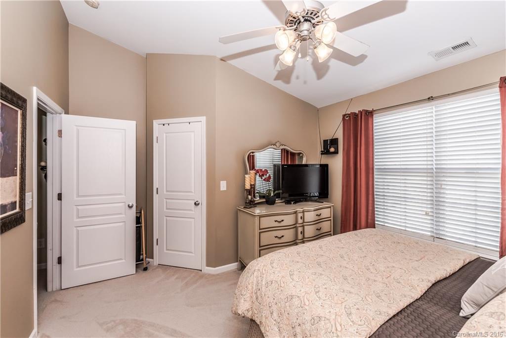 816 Gentlewinds Court, Unit 816 Fort Mill, SC 29708 - Photo 17 of 24 a bedroom with a bed and a flat screen tv