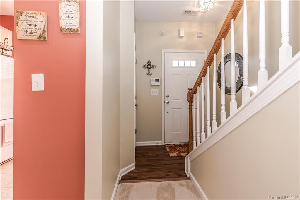 816 Gentlewinds Court, Unit 816 Fort Mill, SC 29708 - Photo 3 of 24 a view of a hallway with wooden floor and staircase