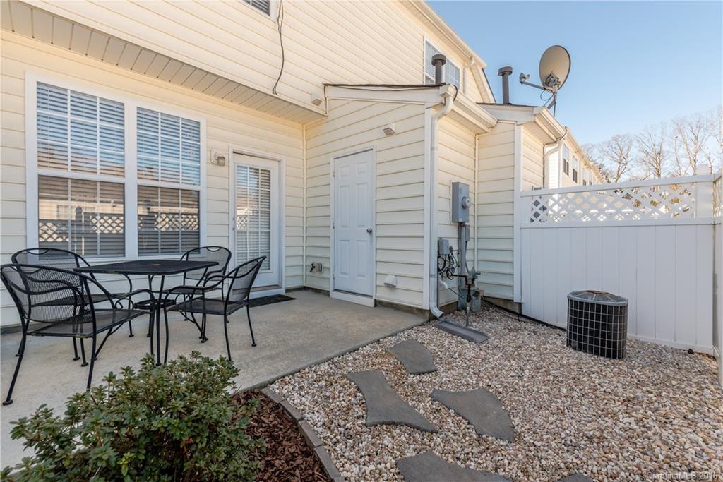 816 Gentlewinds Court, Unit 816 Fort Mill, SC 29708 - Photo 21 of 24 a backyard of a house with table and chairs