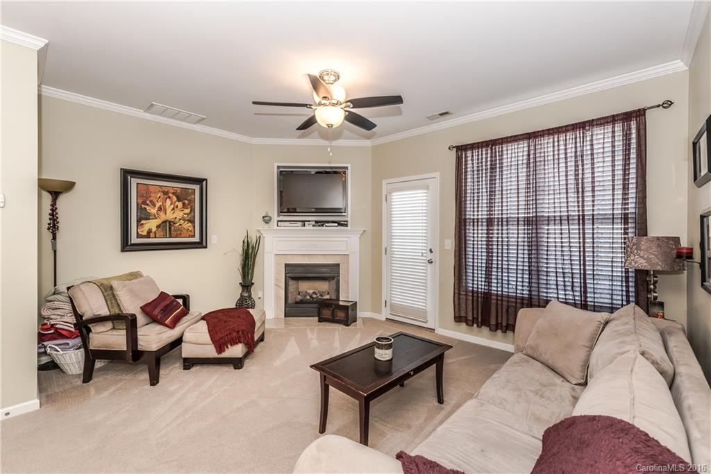 816 Gentlewinds Court, Unit 816 Fort Mill, SC 29708 - Photo 9 of 24 a living room with furniture ceiling fan and a fireplace