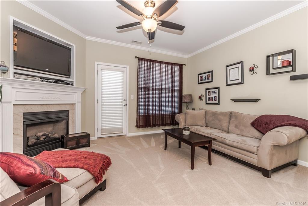 816 Gentlewinds Court, Unit 816 Fort Mill, SC 29708 - Photo 10 of 24 a living room with furniture and a fireplace